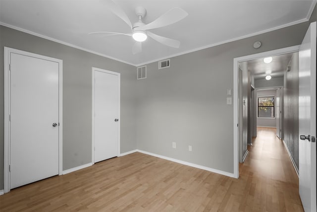 unfurnished bedroom featuring ceiling fan, crown molding, and light hardwood / wood-style flooring