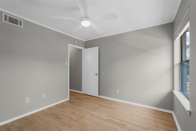 unfurnished room with ceiling fan, light hardwood / wood-style floors, and ornamental molding