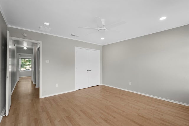 unfurnished bedroom featuring ceiling fan, light wood-type flooring, ornamental molding, and a closet