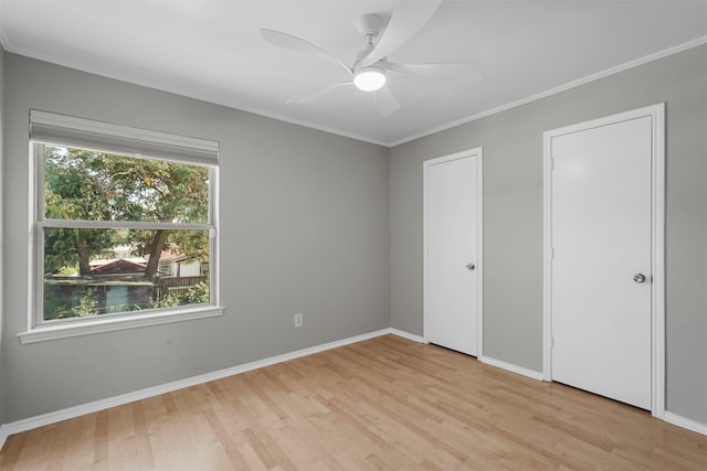 unfurnished bedroom featuring ceiling fan, light hardwood / wood-style flooring, and ornamental molding