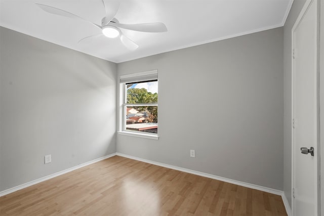 spare room featuring ceiling fan, crown molding, and light wood-type flooring