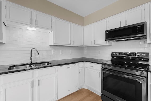 kitchen featuring sink, white cabinets, stainless steel appliances, and light hardwood / wood-style floors