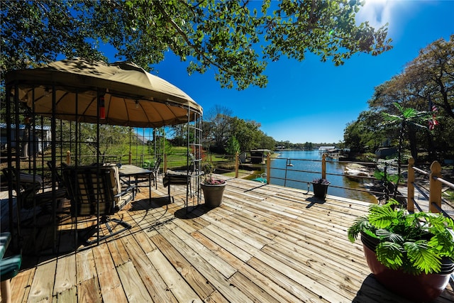 wooden deck with a gazebo and a water view