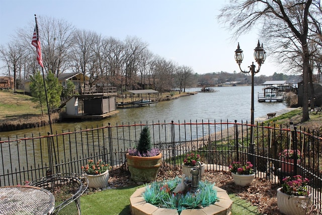 exterior space featuring a dock and a water view