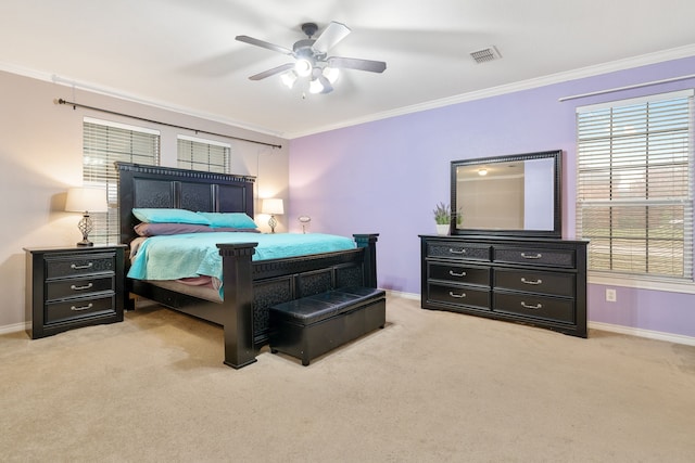 carpeted bedroom with ceiling fan and ornamental molding