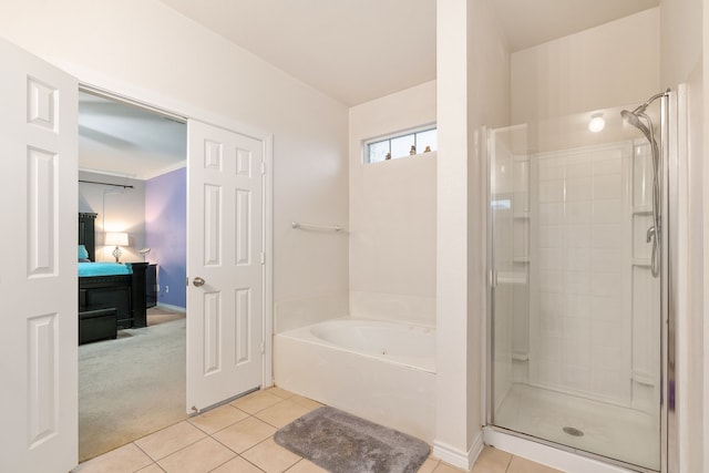 bathroom featuring tile patterned floors and separate shower and tub