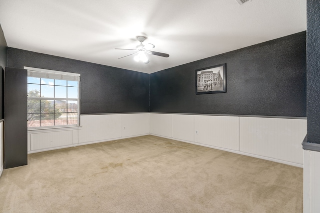 empty room featuring light carpet and ceiling fan