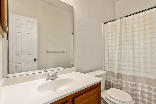 bathroom with vanity, toilet, and walk in shower