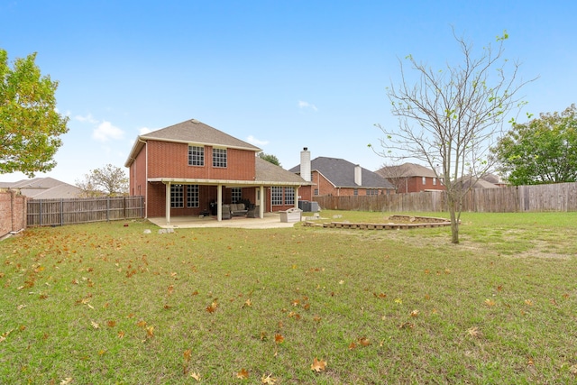 back of property featuring a yard, cooling unit, and a patio area