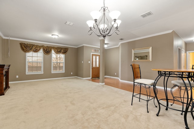 dining space featuring an inviting chandelier, light colored carpet, and ornamental molding