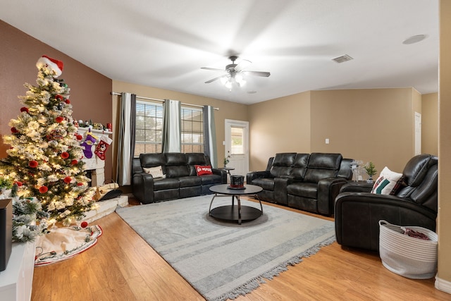 living room with ceiling fan and light wood-type flooring