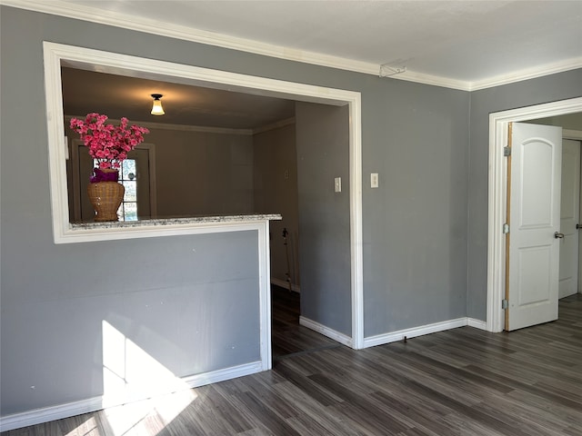 spare room featuring dark hardwood / wood-style floors and ornamental molding