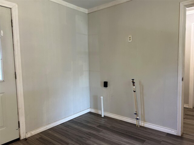 clothes washing area featuring dark hardwood / wood-style flooring and ornamental molding