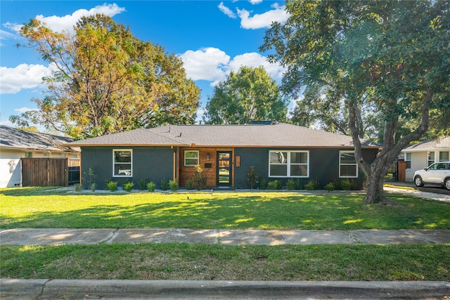 ranch-style home with a front lawn