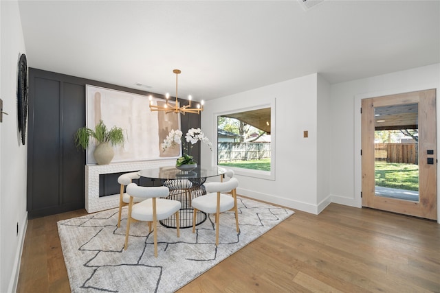 dining space featuring an inviting chandelier and hardwood / wood-style flooring