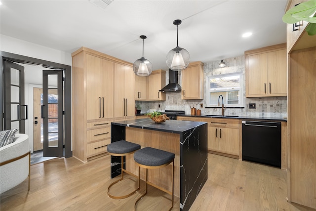 kitchen with dishwasher, light brown cabinetry, and wall chimney exhaust hood