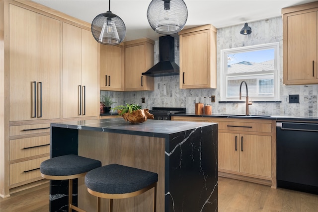 kitchen featuring wall chimney range hood, sink, light brown cabinets, black appliances, and a kitchen island