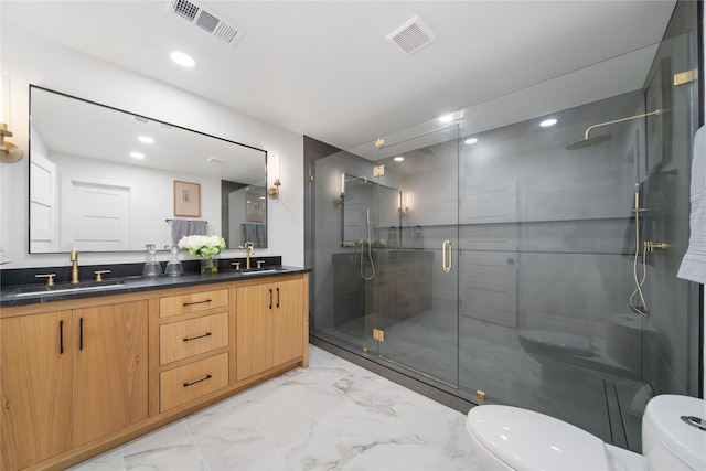 bathroom featuring vanity, toilet, and an enclosed shower