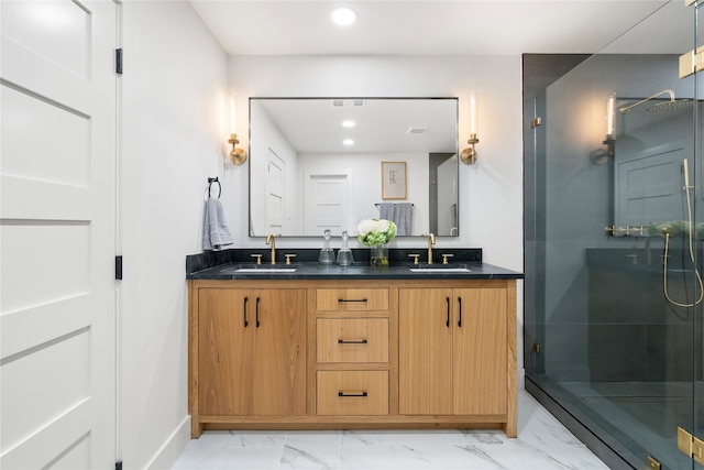 bathroom with vanity and a shower with shower door