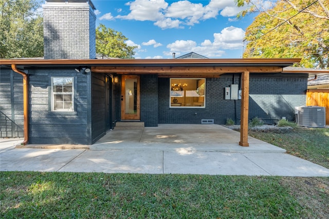 view of front of house featuring a patio area and central AC