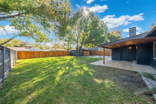 view of yard with a patio and a storage unit