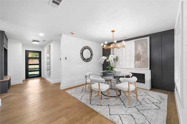 dining room featuring light hardwood / wood-style flooring and an inviting chandelier