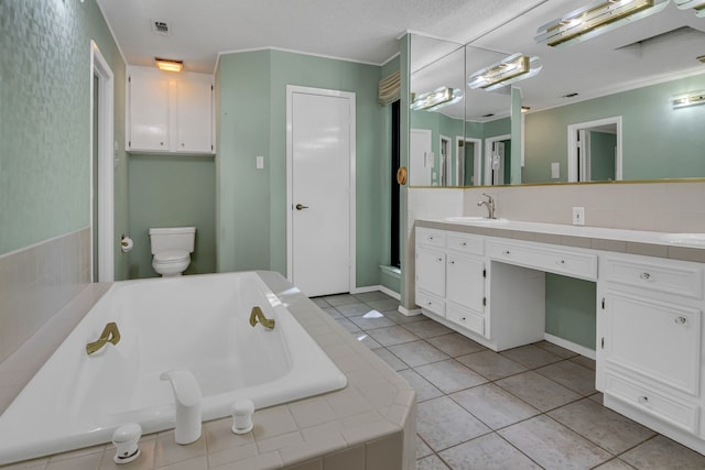 bathroom with tile patterned floors, vanity, toilet, and a bathing tub