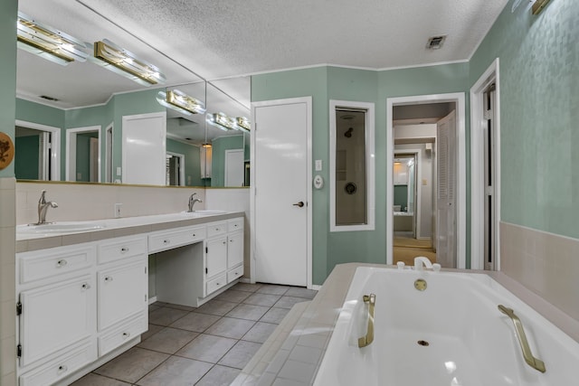 bathroom featuring vanity, backsplash, a bathing tub, tile patterned flooring, and a textured ceiling