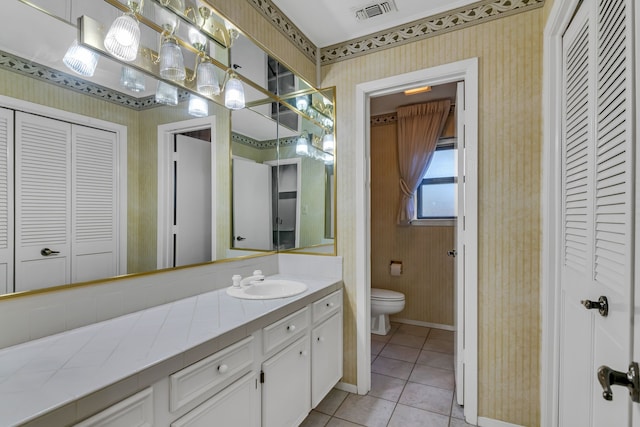 bathroom featuring tile patterned floors, vanity, and toilet