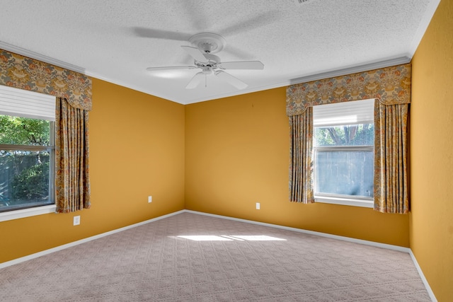 carpeted empty room with a textured ceiling, ceiling fan, and ornamental molding