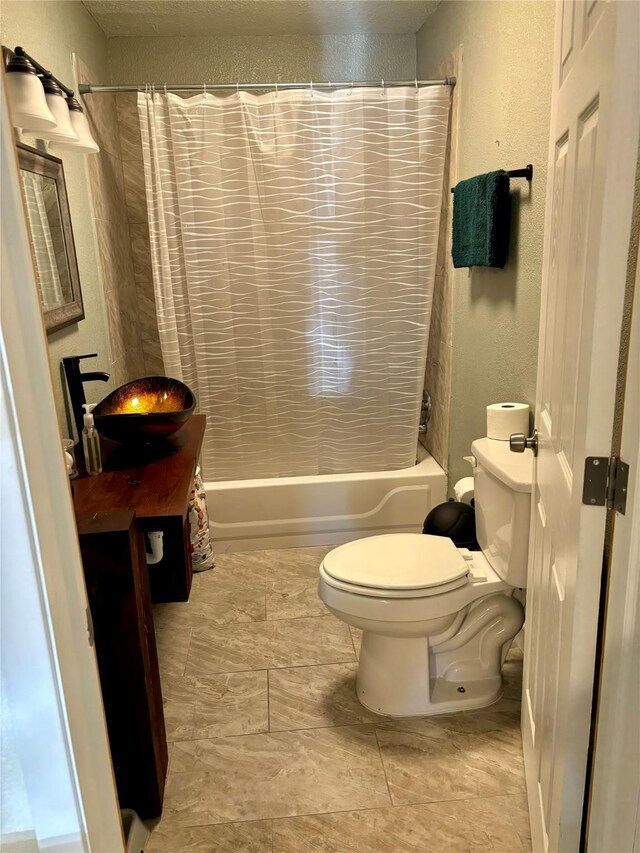 full bathroom with sink, shower / bath combo, and toilet