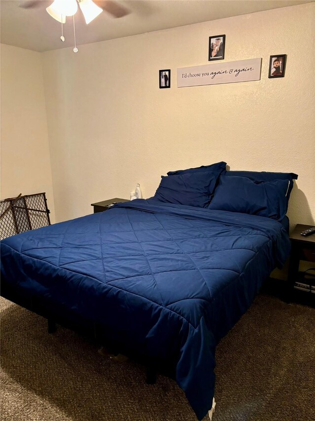 bedroom featuring ceiling fan and carpet