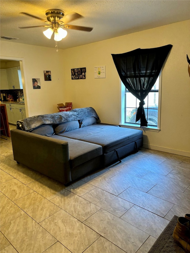 bedroom featuring ceiling fan and a textured ceiling