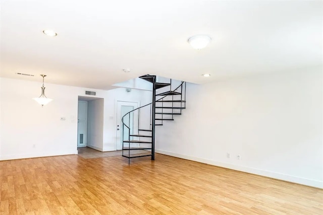 basement with light hardwood / wood-style floors