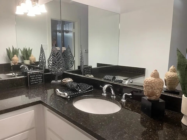 bathroom featuring vanity and an inviting chandelier