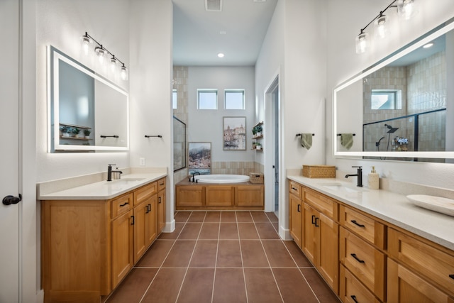 bathroom with vanity, tile patterned flooring, and plus walk in shower