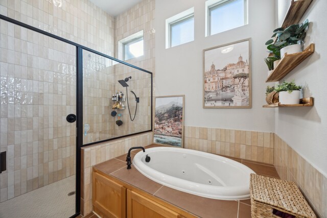 bathroom featuring shower with separate bathtub