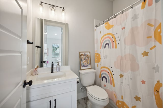 bathroom with curtained shower, vanity, and toilet