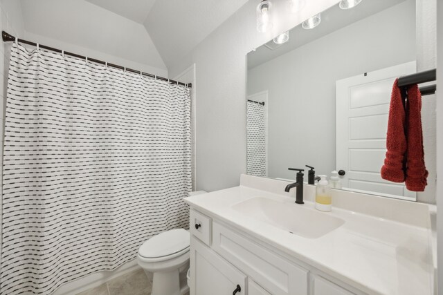 bathroom with vanity, tile patterned floors, a shower with curtain, vaulted ceiling, and toilet