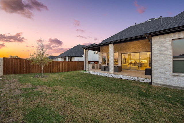 yard at dusk with a patio