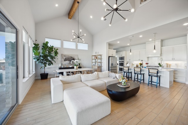 living room with high vaulted ceiling, sink, light hardwood / wood-style flooring, beamed ceiling, and a chandelier