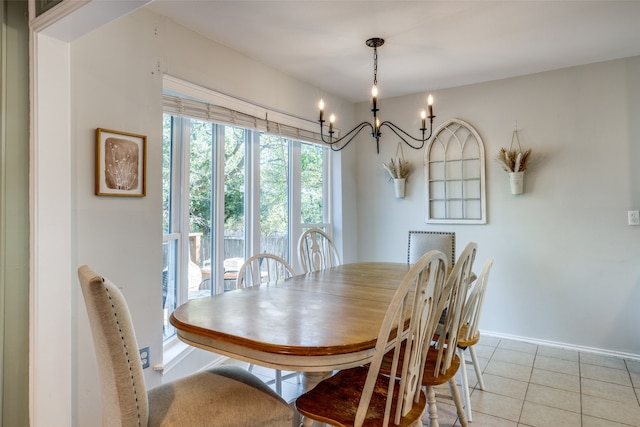 dining space with light tile patterned floors and an inviting chandelier