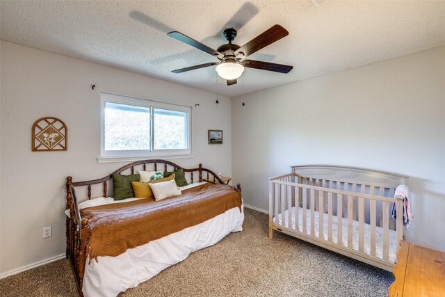 carpeted bedroom featuring a textured ceiling and ceiling fan