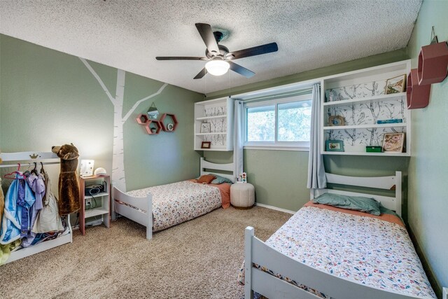 carpeted bedroom with ceiling fan and a textured ceiling