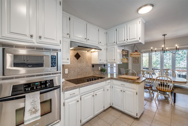 kitchen with white cabinetry, a notable chandelier, kitchen peninsula, light tile patterned flooring, and appliances with stainless steel finishes