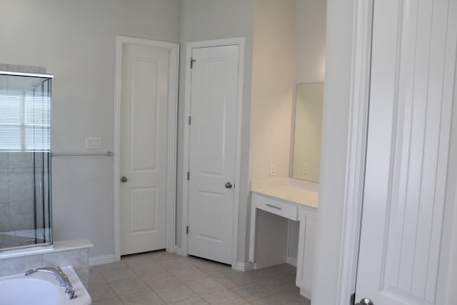 laundry area featuring electric dryer hookup, hookup for a gas dryer, and light tile patterned floors