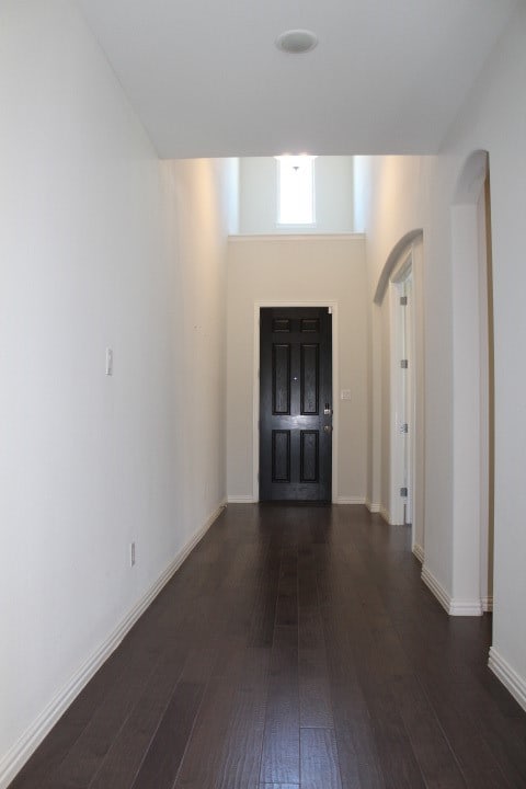 corridor featuring dark hardwood / wood-style flooring