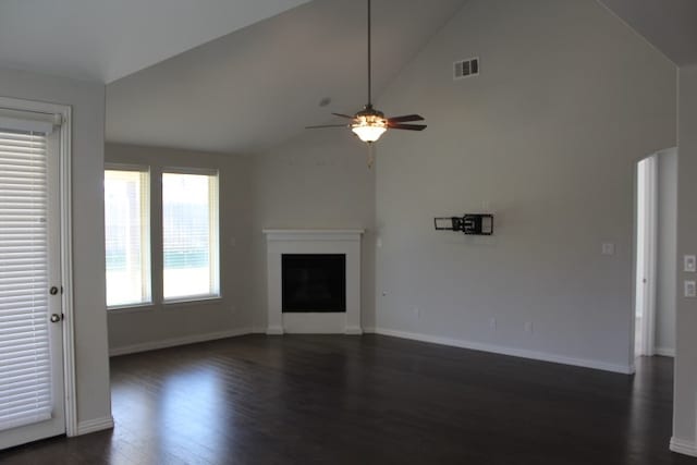 unfurnished living room featuring dark hardwood / wood-style flooring, high vaulted ceiling, and ceiling fan