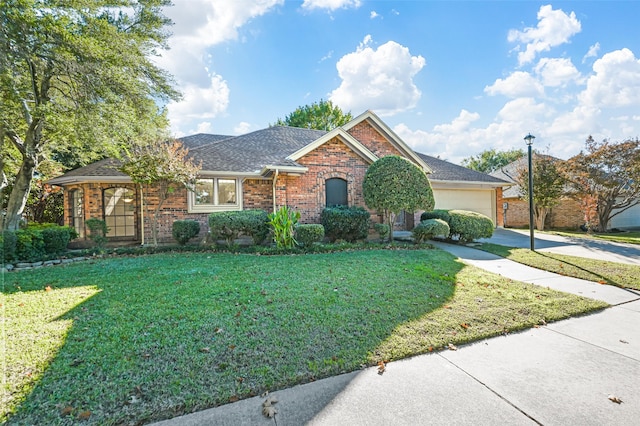 view of front of home with a garage and a front yard