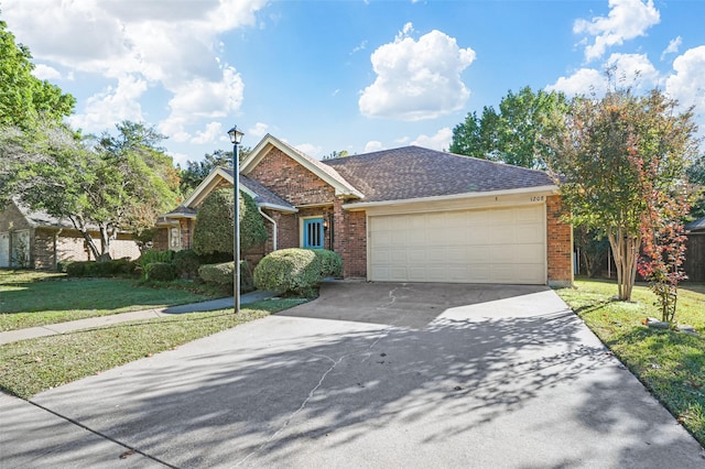 view of front of property with a front yard and a garage